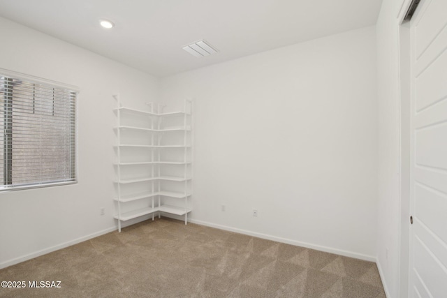 empty room featuring light carpet, recessed lighting, visible vents, and baseboards