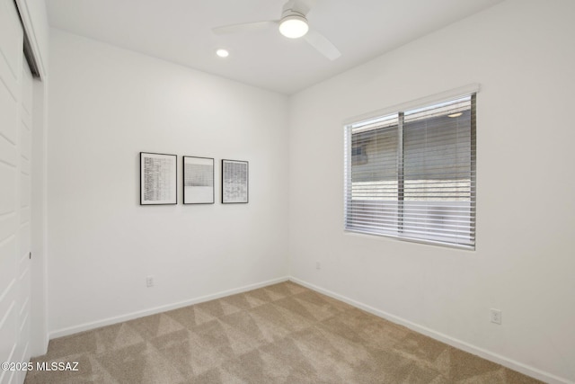 spare room with baseboards, recessed lighting, ceiling fan, and light colored carpet