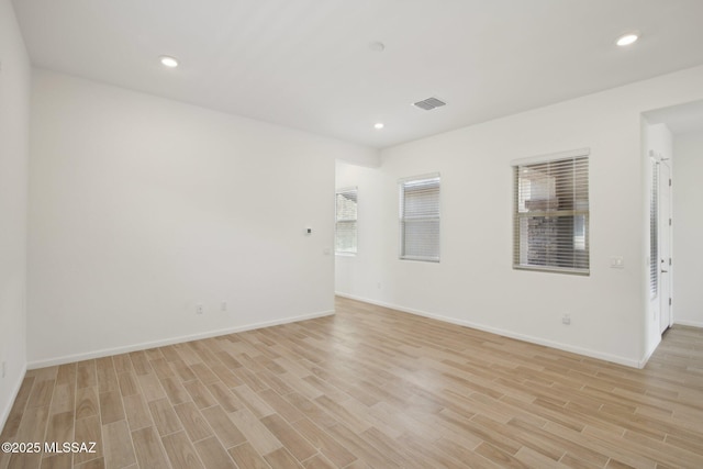 empty room with recessed lighting, visible vents, and light wood-type flooring