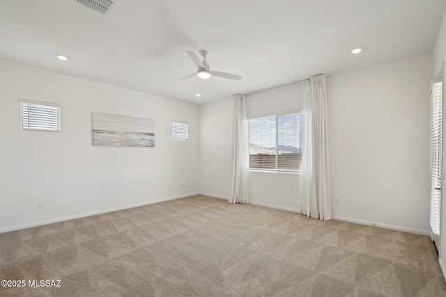 carpeted empty room with visible vents, baseboards, a ceiling fan, and recessed lighting