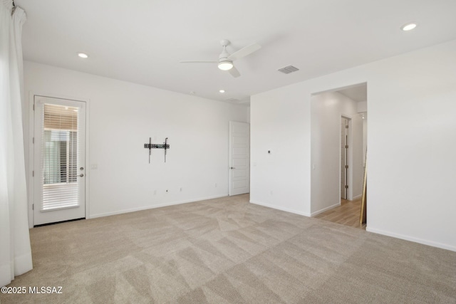 empty room with light carpet, ceiling fan, baseboards, and recessed lighting