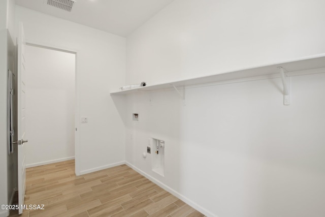 washroom with hookup for a washing machine, laundry area, light wood finished floors, baseboards, and visible vents