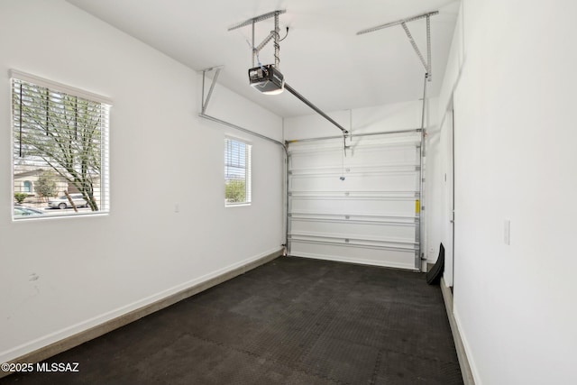 garage with baseboards and a garage door opener