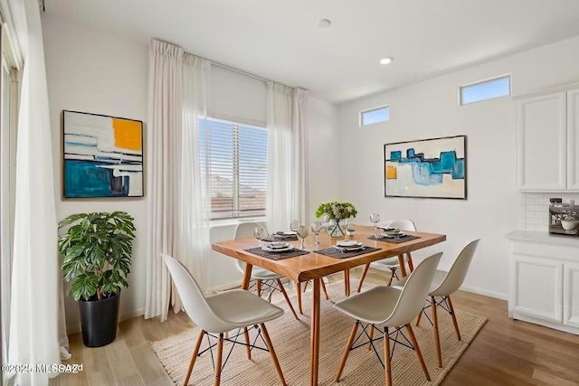 dining area with recessed lighting, light wood finished floors, and baseboards