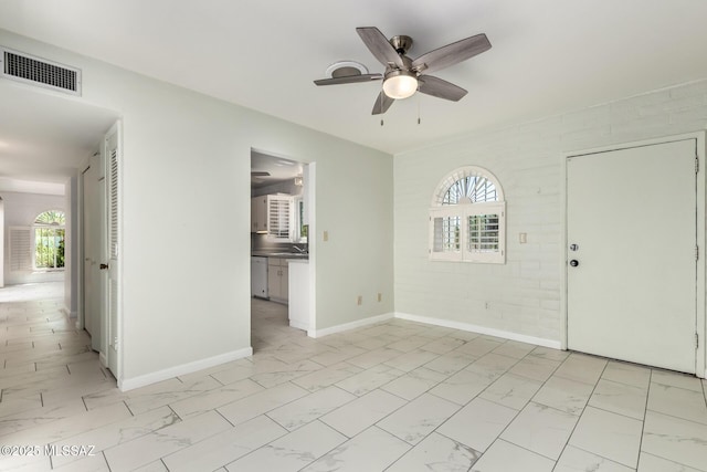 interior space with baseboards, visible vents, marble finish floor, and ceiling fan