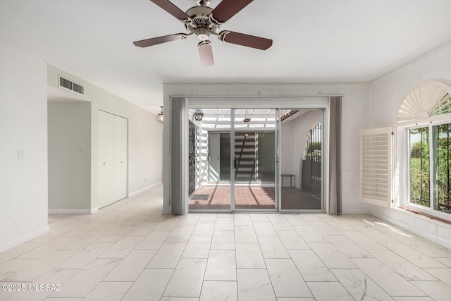 unfurnished room with marble finish floor, baseboards, a ceiling fan, and visible vents