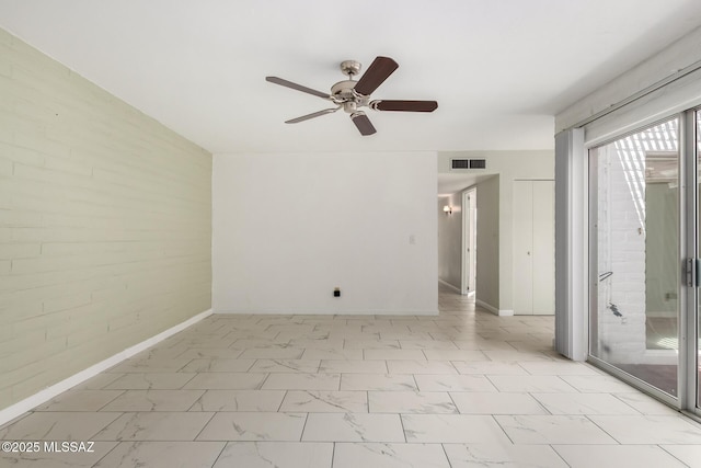 empty room with ceiling fan, baseboards, marble finish floor, and visible vents