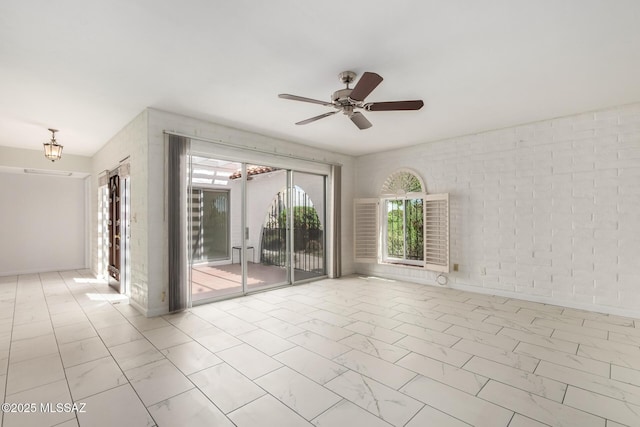 unfurnished room with marble finish floor and ceiling fan