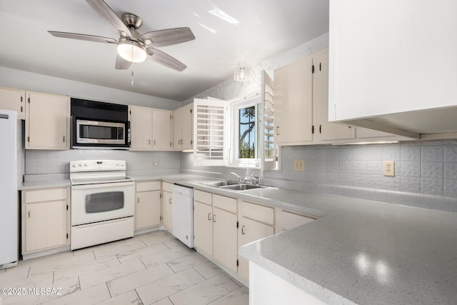 kitchen with marble finish floor, a sink, white appliances, and light countertops