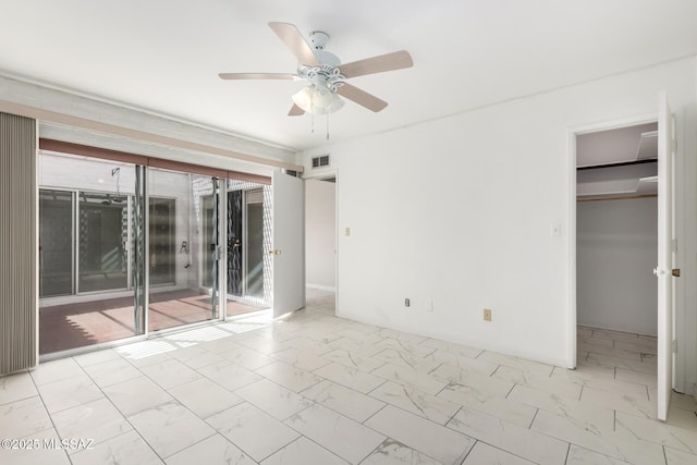 unfurnished bedroom featuring visible vents, baseboards, marble finish floor, and a spacious closet
