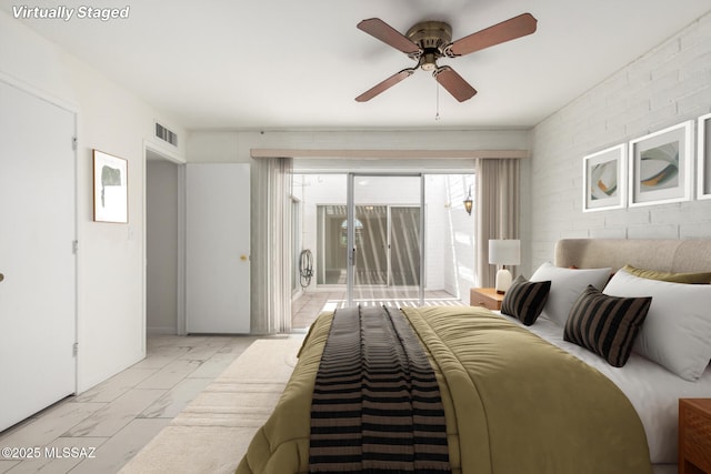 bedroom with ceiling fan, visible vents, marble finish floor, and access to outside