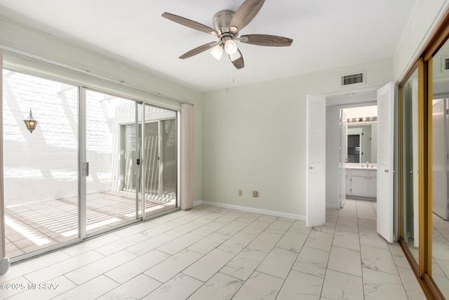 unfurnished room featuring visible vents, baseboards, marble finish floor, and ceiling fan