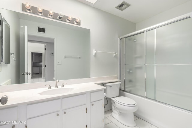 full bath featuring visible vents, toilet, vanity, and bath / shower combo with glass door