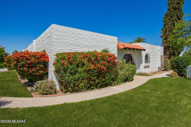 view of home's exterior featuring a yard