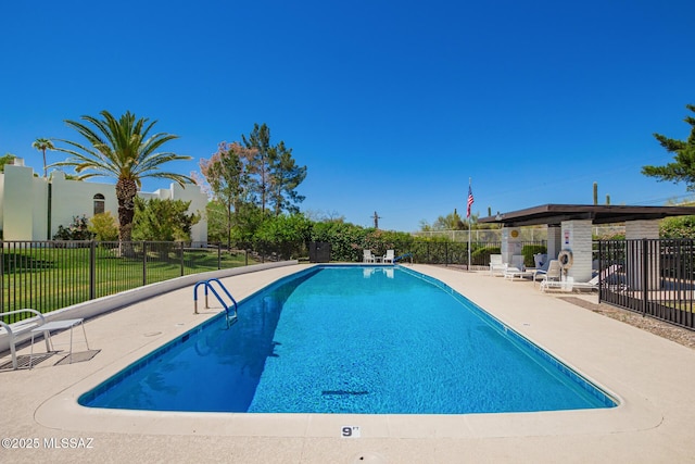 pool with fence and a patio