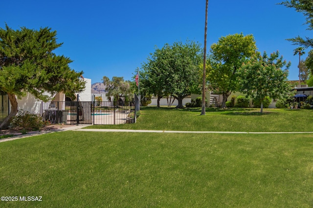 surrounding community with fence and a yard