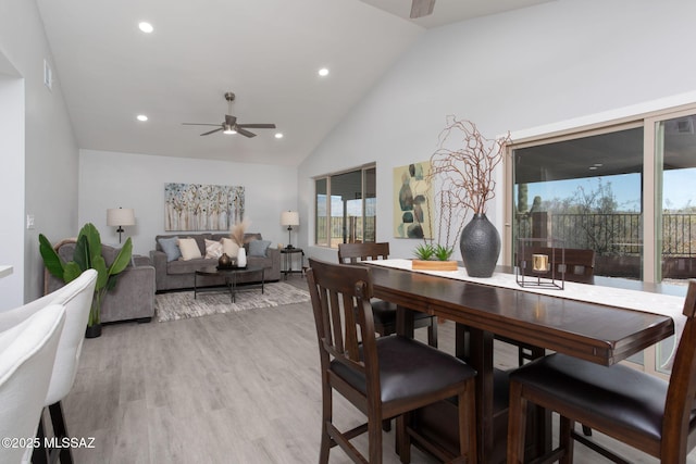 dining space featuring recessed lighting, light wood-style flooring, ceiling fan, and high vaulted ceiling