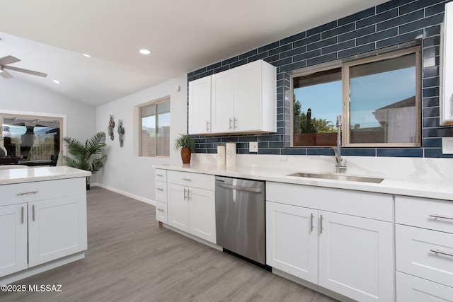 kitchen with a sink, light countertops, ceiling fan, and dishwasher