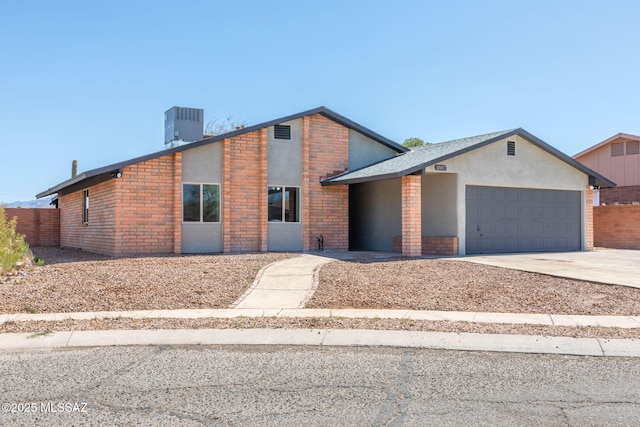 mid-century home with brick siding, central AC, concrete driveway, an attached garage, and stucco siding