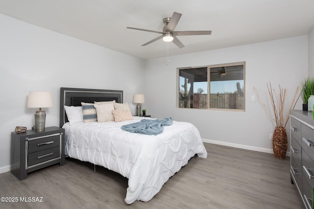 bedroom featuring baseboards, a ceiling fan, and wood finished floors