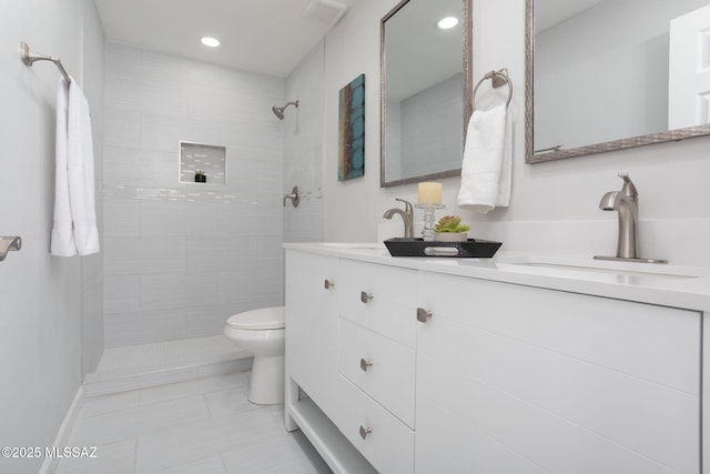 bathroom with tile patterned flooring, recessed lighting, a tile shower, and toilet