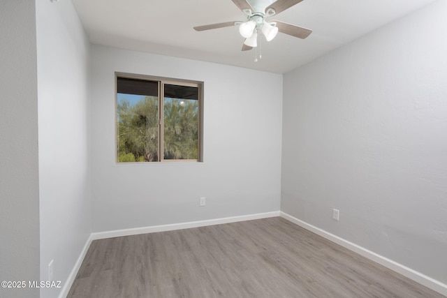 unfurnished room featuring baseboards, a ceiling fan, and wood finished floors