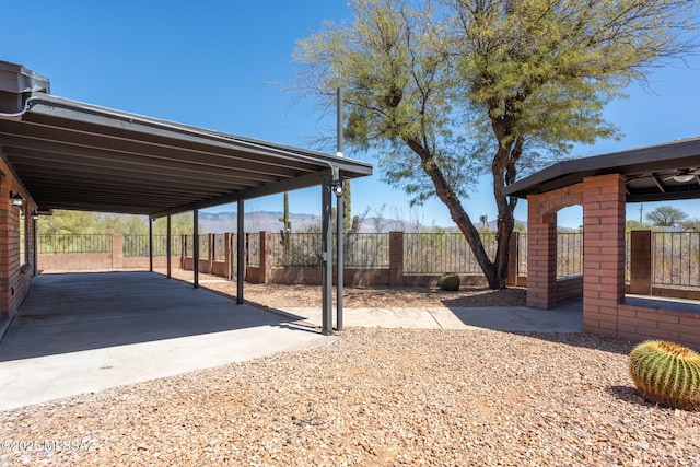 view of yard featuring a mountain view and fence