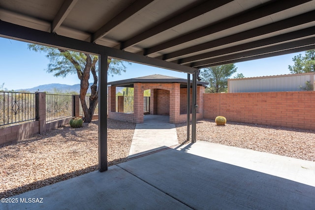 view of patio featuring a fenced backyard, a mountain view, and a gazebo