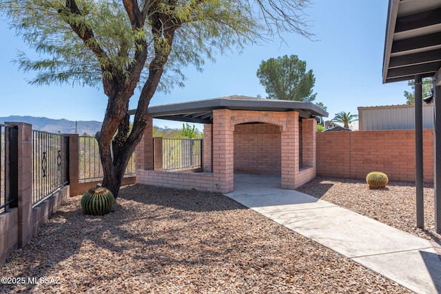 exterior space featuring a mountain view and a fenced backyard