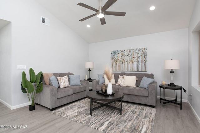 living room with visible vents, ceiling fan, wood finished floors, and vaulted ceiling