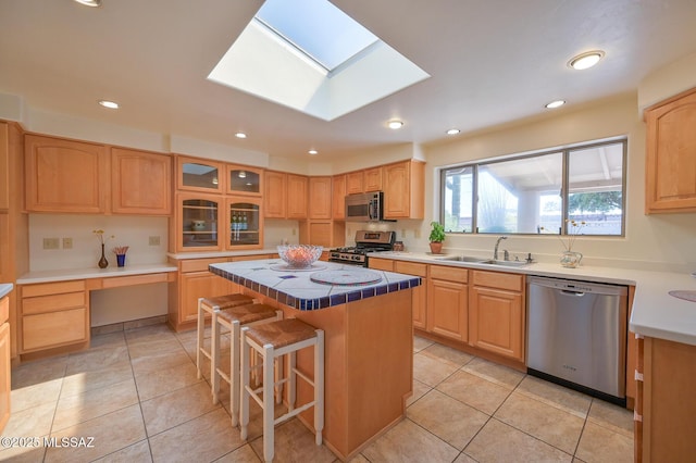 1402 N Camino Miraflores, Tucson, AZ 85745 - kitchen featuring stainless steel appliances, a sink, a kitchen island, light tile patterned floors, and recessed lighting