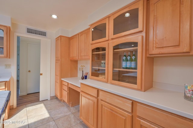 1402 N Camino Miraflores, Tucson, AZ 85745 - kitchen with recessed lighting, light countertops, glass insert cabinets, and light tile patterned floors