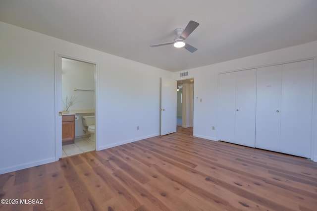 1402 N Camino Miraflores, Tucson, AZ 85745 - unfurnished bedroom with light wood finished floors, baseboards, a closet, ensuite bathroom, and ceiling fan