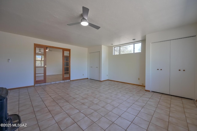 1402 N Camino Miraflores, Tucson, AZ 85745 - unfurnished bedroom with french doors, baseboards, ceiling fan, and light tile patterned floors