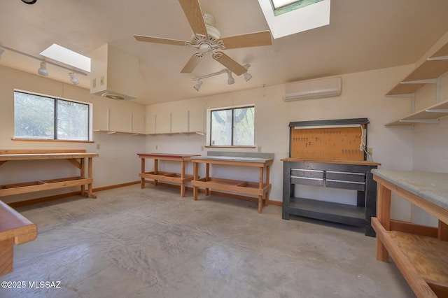 1402 N Camino Miraflores, Tucson, AZ 85745 - miscellaneous room featuring a workshop area, a wall mounted AC, a skylight, and concrete floors