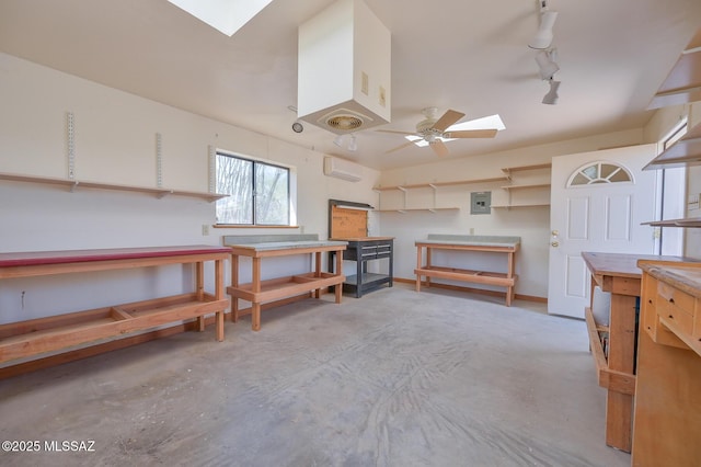 1402 N Camino Miraflores, Tucson, AZ 85745 - miscellaneous room with a skylight, a workshop area, concrete floors, a wall mounted AC, and a ceiling fan