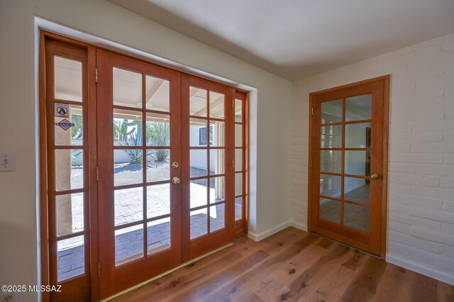 1402 N Camino Miraflores, Tucson, AZ 85745 - doorway to outside featuring french doors, wood finished floors, and baseboards