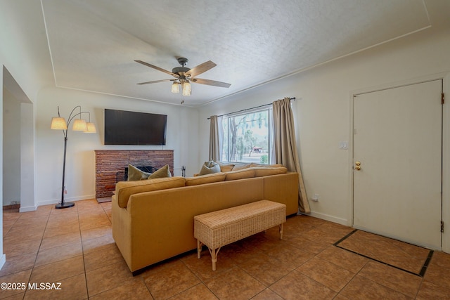 3315 N Tucson Blvd, Tucson, AZ 85716 - living area with a ceiling fan, light tile patterned flooring, baseboards, a textured ceiling, and a fireplace