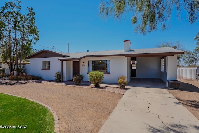 3315 N Tucson Blvd, Tucson, AZ 85716 - ranch-style house featuring a carport, concrete driveway, a chimney, and stucco siding