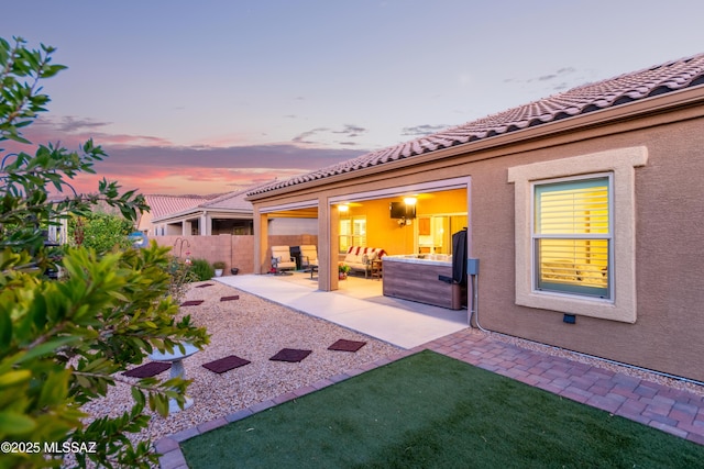 back of house featuring stucco siding, a patio area, a yard, a tiled roof, and fence
