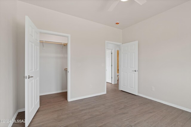 unfurnished bedroom featuring wood finished floors and baseboards