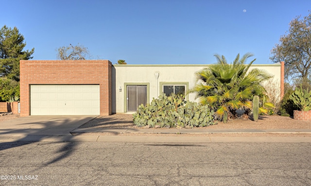 401 E Placita Del Venado, Green Valley, AZ 85614 - view of front of property with an attached garage, concrete driveway, and stucco siding
