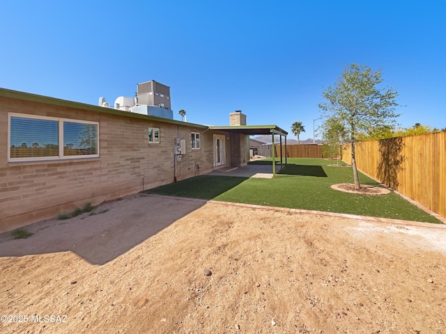 view of yard with a patio area and a fenced backyard