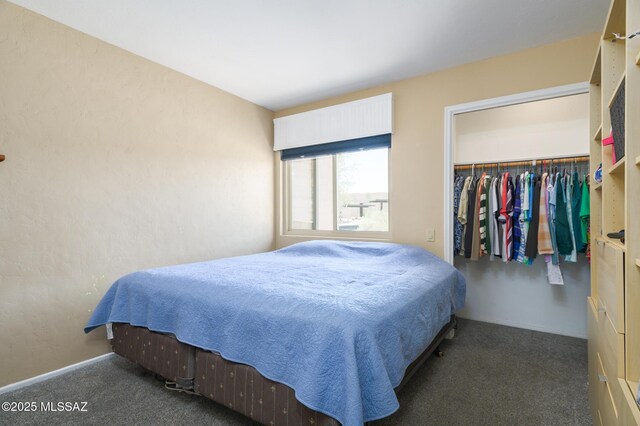 carpeted bedroom featuring a closet and baseboards