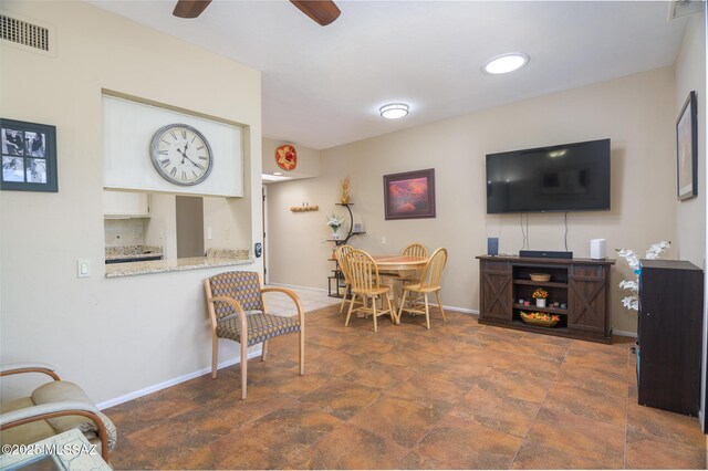 dining space featuring baseboards, a ceiling fan, and visible vents