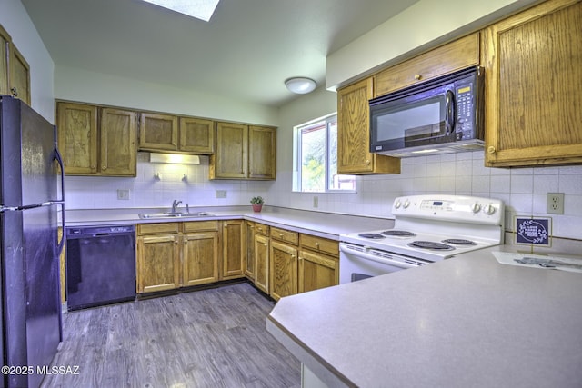 3061 W Avenida Cresta, Tucson, AZ 85745 - kitchen featuring black appliances, a sink, dark wood-type flooring, decorative backsplash, and brown cabinetry
