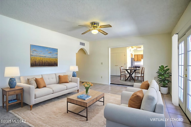 3061 W Avenida Cresta, Tucson, AZ 85745 - living area featuring arched walkways, tile patterned floors, ceiling fan, and a textured ceiling