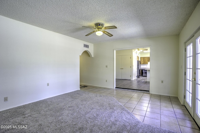 3061 W Avenida Cresta, Tucson, AZ 85745 - empty room featuring a ceiling fan, arched walkways, tile patterned floors, and a textured ceiling