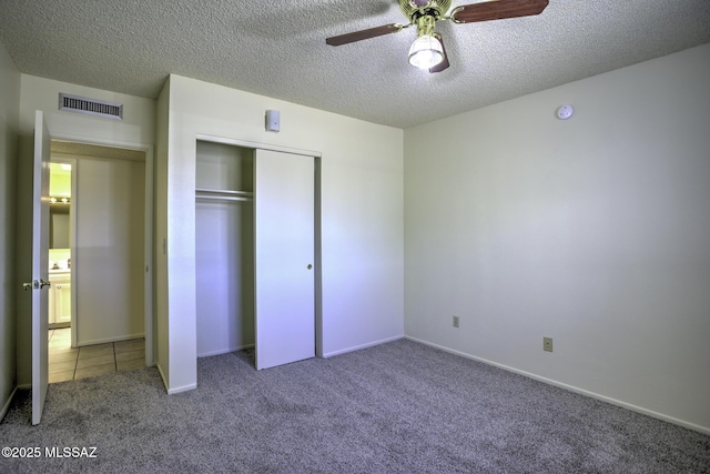 3061 W Avenida Cresta, Tucson, AZ 85745 - unfurnished bedroom featuring carpet flooring, a textured ceiling, a closet, ceiling fan, and baseboards