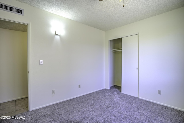3061 W Avenida Cresta, Tucson, AZ 85745 - unfurnished bedroom featuring carpet flooring, a textured ceiling, a closet, and baseboards